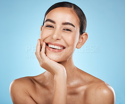 Buy stock photo Portrait, beauty and smile with a model woman in studio on a blue background for natural skincare. Face, skin and cosmetics with an attractive young female posing to promote a luxury product
