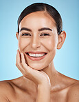 Wellness, portrait and woman in a studio with a skincare, facial and natural beauty routine. Health, self care and happy female model with a cosmetic face or skin treatment by a blue background.