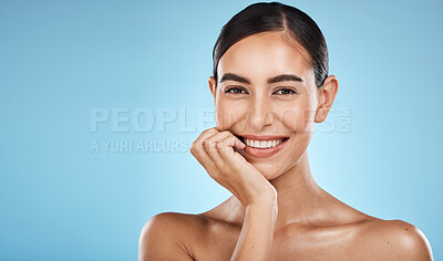 Buy stock photo Skincare, beauty and portrait of a woman in a studio with a cosmetic, facial and natural routine. Health, wellness and happy female model with a skin treatment by a blue background with mockup space.