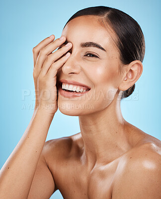 Buy stock photo Skincare, wellness and happy woman in a studio for a cosmetic, health and natural face routine. Self care, happiness and excited female model with a facial skin treatment isolated by blue background.
