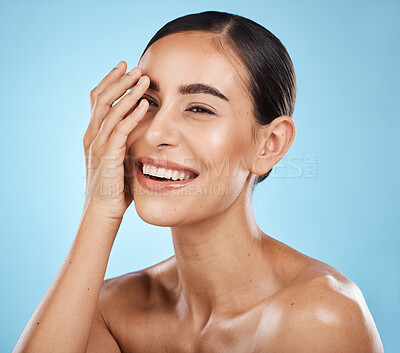 Buy stock photo Beauty, skincare and happy woman in a studio for a wellness, health and natural face routine. Self care, cosmetic and excited female model with a facial skin treatment isolated by blue background.