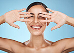 Face, hands and beauty skincare of woman in studio isolated on a blue background. Portrait, makeup and cosmetics of female model with healthy, glowing and flawless skin after spa facial treatment.