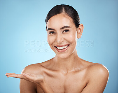 Buy stock photo Portrait, beauty skincare and woman with product placement in studio isolated on a blue background. Face makeup, cosmetics and female model with marketing, advertising or branding space for mockup.