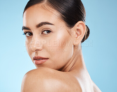 Buy stock photo Portrait, beauty and shoulder with a model woman in studio on a blue background for natural skincare. Face, skin and cosmetics with an attractive young female posing to promote a luxury product