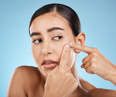 Buy stock photo Woman, face and pop pimple with hands and acne, anxiety and stress, beauty and skincare isolated on blue background. Skin problem, facial and cosmetics, dermatology and cosmetic care in studio