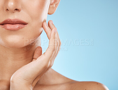 Buy stock photo Half, face and woman for skincare, beauty and touching isolated on a blue background in a studio. Mockup, cosmetics and facial check of a model feeling skin for acne, problem and eczema on a backdrop