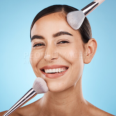 Buy stock photo Face portrait, beauty and makeup brush of woman in studio isolated on blue background. Aesthetics, facial treatment or skincare of happy female model with brushes for foundation, powder or cosmetics.