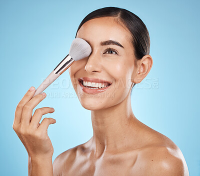 Buy stock photo Face, beauty and makeup brush of woman in studio isolated on a blue background. Thinking, facial treatment and  skincare aesthetic of happy female model with tools for foundation, powder or cosmetics