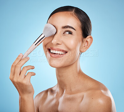 Buy stock photo Beauty, face and makeup brush of woman in studio isolated on a blue background. Thinking, facial treatment and  skincare aesthetic of happy female model with tools for foundation, powder or cosmetics