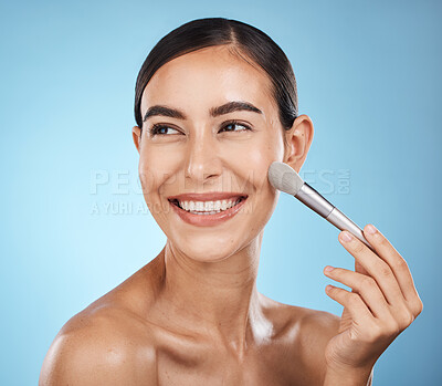 Buy stock photo Cosmetics, happy and woman with a brush for makeup isolated on a blue background in a studio. Skincare, beauty and model thinking of cosmetology, foundation and body health on a backdrop with a smile