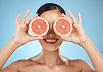 Skin care, grapefruit and beauty woman fruit face for dermatology, cosmetics and wellness. Aesthetic model for natural sustainable facial glow, nutrition diet and healthy smile on blue background