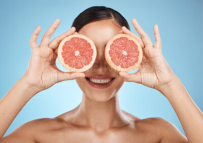 Buy stock photo Skin care, grapefruit and beauty woman fruit face for dermatology, cosmetics and wellness. Aesthetic model for natural sustainable facial glow, nutrition diet and healthy smile on blue background