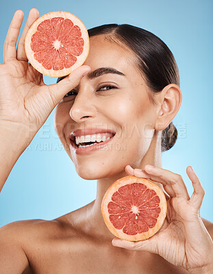 Buy stock photo Portrait, face and skincare of woman with grapefruit in studio isolated on a blue background. Organic cosmetics, food and female model with fruits for nutrition, healthy diet or vitamin c for beauty.