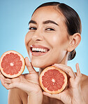 Face, skincare and portrait of woman with grapefruit in studio isolated on a blue background. Organic cosmetics, food and female model with fruits for nutrition, healthy diet or vitamin c for beauty.