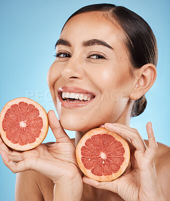 Buy stock photo Face, skincare and portrait of woman with grapefruit in studio isolated on a blue background. Organic cosmetics, food and female model with fruits for nutrition, healthy diet or vitamin c for beauty.