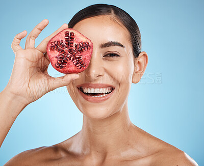 Buy stock photo Beauty, skin care and woman portrait with pomegranate fruit face for dermatology and cosmetics. Aesthetic model person for natural product facial glow, nutrition and healthy smile on blue background