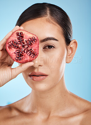 Buy stock photo Skin care, beauty and woman portrait with pomegranate fruit face for dermatology and cosmetics. Aesthetic model person for natural product facial glow, nutrition and healthy diet on blue background