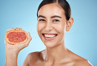 Buy stock photo Skin care, beauty and grapefruit squeeze woman portrait for dermatology, natural cosmetic and wellness. Face of aesthetic model for fruit glow facial, nutrition diet and healthy smile blue background