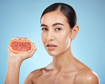Buy stock photo Face, beauty and grapefruit squeeze woman portrait for dermatology, natural cosmetic and wellness. Aesthetic model person for vitamin c fruit facial glow, nutrition diet and skin care blue background