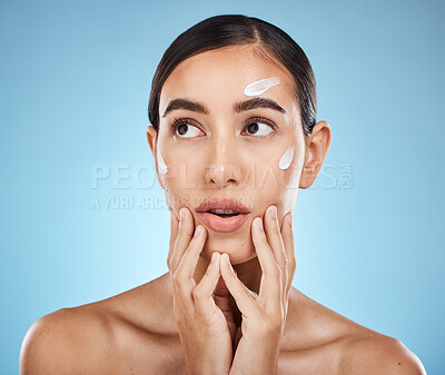 Buy stock photo Beauty cream, skin care and face of a woman with hands for dermatology, cosmetics and natural glow. Aesthetic model person with secret spa facial lotion for health and wellness on a blue background