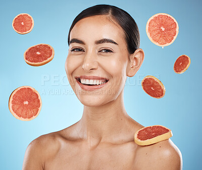 Buy stock photo Woman, studio portrait and grapefruit with beauty skincare, smile or happy for wellness by blue background. Young gen z model, healthy face skin or citrus fruit for vitamin c with self care happiness