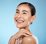 Woman, face and smile, happy and beauty with natural cosmetics and glow isolated against blue background. Clean, cosmetic care and hand with facial, makeup and healthy skin with skincare in studio
