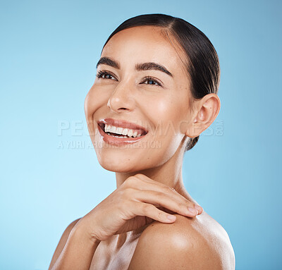 Buy stock photo Woman, face and smile, happy and beauty with natural cosmetics and glow isolated against blue background. Clean, cosmetic care and hand with facial, makeup and healthy skin with skincare in studio