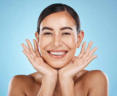 Buy stock photo Skincare, facial and portrait of woman with smile on blue background for luxury, wellness and cosmetics. Spa aesthetic, dermatology and face of girl with hands for beauty, treatment and healthy skin