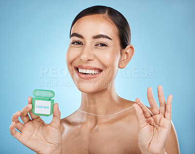 Buy stock photo Woman, floss and smile in portrait with dental healthcare, fresh breath and teeth cleaning isolated on blue background. Face, happy and oral hygiene product, mouth health with healthy gums in studio