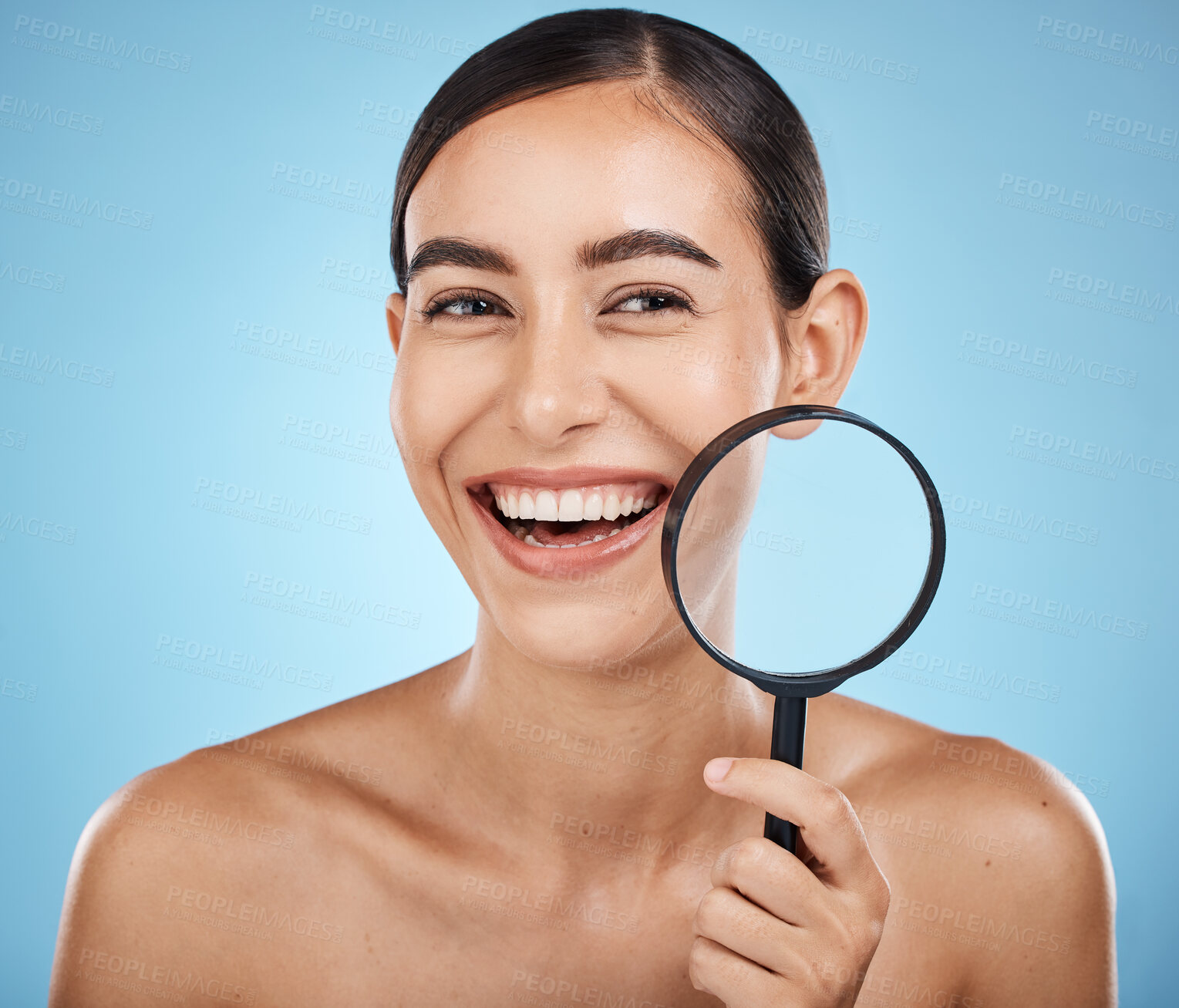 Buy stock photo Face skincare, magnifying glass and beauty of woman in studio isolated on a blue background. Facial portrait, makeup and cosmetics of female model with magnifier lens to check aesthetic wellness.