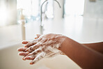 Woman, hands and cleaning with soap, water and tap at home for hygiene. Closeup, hand skincare and bacteria risk in bathroom, house and safety for healthy lifestyle, wellness and self care at sink 