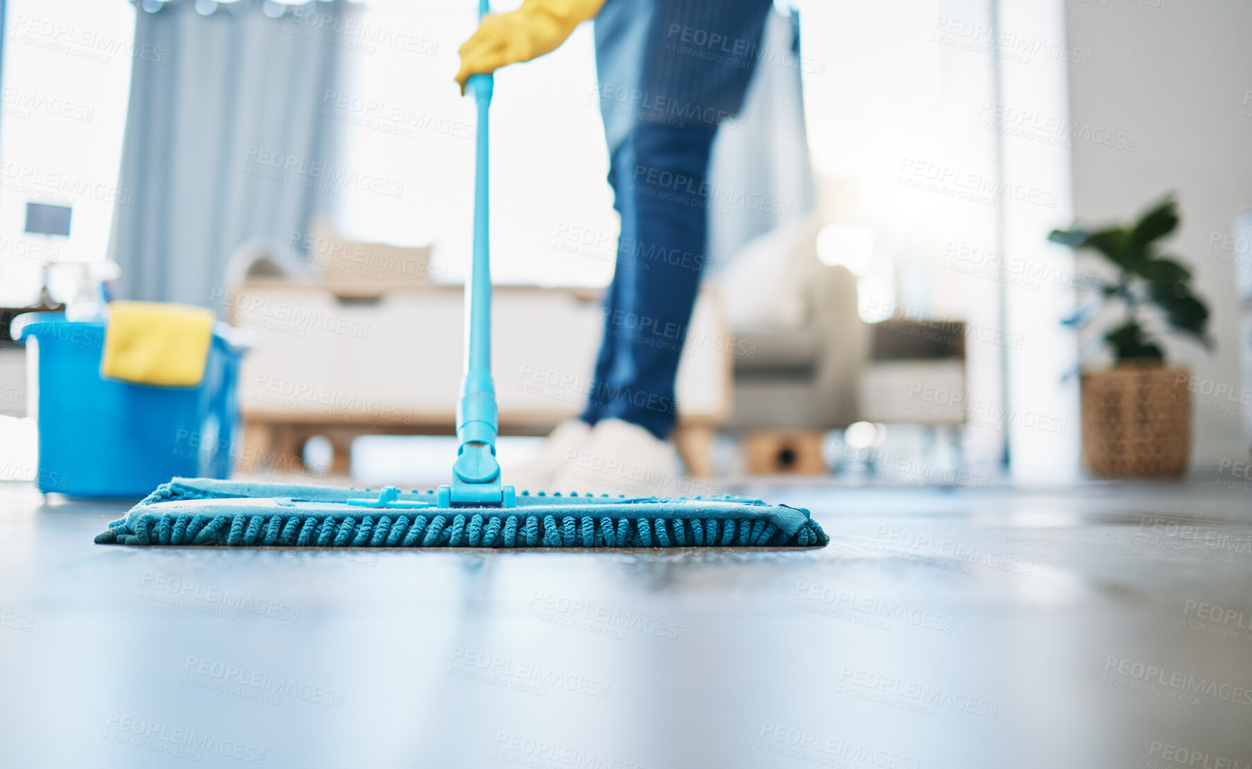 Buy stock photo Housekeeping, cleaning and woman maid with a mop to clean the living room floor at a house. Female domestic worker, cleaner and housewife washing the ground for bacteria, dust or dirt in her home.