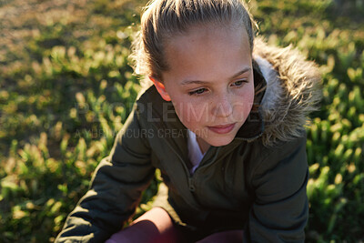 Buy stock photo Nature, summer and girl sitting on the grass in a park after playing alone on vacation or weekend trip. Natural, beautiful and child having fun and enjoying in an outdoor field on holiday in Canada.