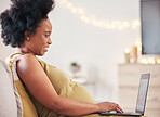 Pregnant, laptop and black woman on sofa typing at home working on a freelance business project. Computer, pregnancy and female remote worker writing report while relaxing on couch in living room.