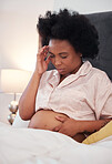 Pregnant, headache and black woman with depression, bedroom and stress with cramps, frustrated and healthcare. Pregnancy, African American female and lady with anxiety, mental health and discomfort