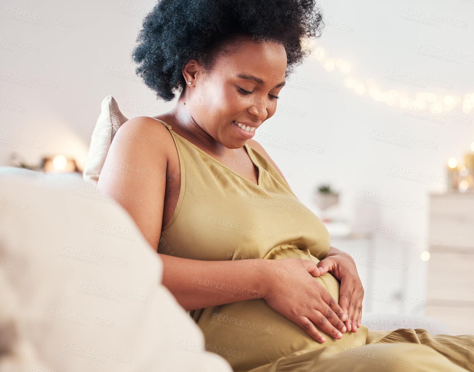 Buy stock photo Pregnant stomach, heart hand sign and happy black woman feeling mother hope and love. Mom care, sofa and living room lounge with a person holding abdomen happy about pregnancy and baby in a house