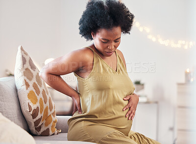 Buy stock photo Back pain, stomach and pregnant woman with healthcare stress, problem or risk on sofa in her living room. Backache, abdomen and pregnancy mother with medical emergency worry, labor or sick on couch