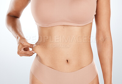 Buy stock photo Model, hand or holding stomach fat for liposuction, weight loss or cosmetic surgery procedure on isolated studio background. Zoom, woman or waist skin for cellulite tummy tuck or body wellness mockup