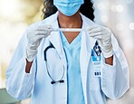 Woman, doctor and hands with test tube, mask and gloves holding covid, flu or DNA sample. Hand of female medical expert with long testing case for examination or experiment in cure for illness