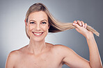 Hair care, health and portrait of a woman in a studio with a keratin, botox and brazilian hair treatment. Happy, wellness and female model with a long, healthy and shiny hair style by gray background