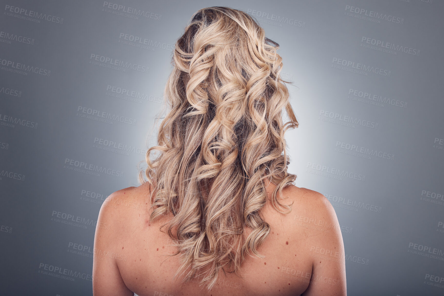 Buy stock photo Hair care, beauty and woman with curly hairstyle texture after salon treatment in a studio. Gray background, isolated and model with hairdresser balayage, dye and growth from haircut and keratin