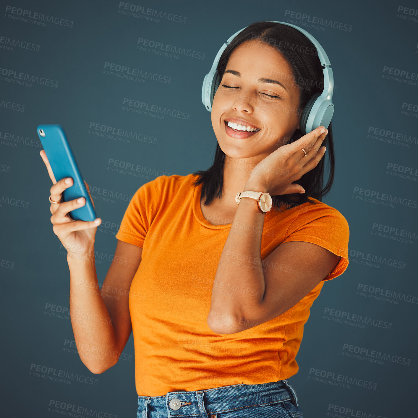 Buy stock photo Radio, headphones and woman listening to music on phone or mobile app isolated against a studio background. Fun, sound and female enjoying and streaming a podcast or audio smiling and happy