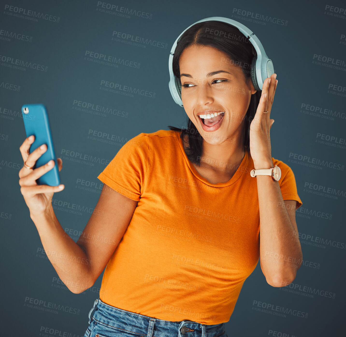 Buy stock photo Selfie, headphones and streaming podcast or music on phone or mobile app isolated against a studio background. Fun, sound and female enjoying and listening to radio or audio smiling and happy