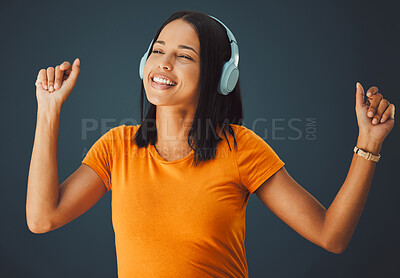 Buy stock photo Dance, black woman or headphones for music, happiness or girl on dark studio background. Dancing, African American female, girl or wireless headset for radio, streaming or listen to audio on backdrop