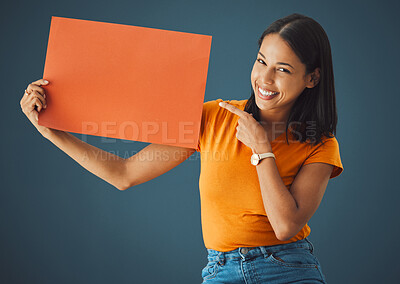 Buy stock photo Woman, poster or banner portrait with mockup space for sale, discount or promotion. Happy model pointing hand advertising product placement, logo or brand billboard on paper sign on blue background