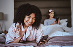 Video call, phone and wave with black woman at sleepover for communication, internet and contact. Happy, relax and smile with girl and friends in bedroom with technology, digital and social media
