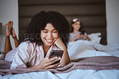 Buy stock photo Contact, phone and smile with black woman at sleepover for communication, internet or online dating. Happy, relax and texting with girl and friends in bedroom with technology, digital or social media