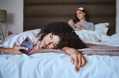 Buy stock photo In love, phone and happy with black woman at sleepover for communication, internet and social media. Text, relax and smile with girl and friends in bedroom with technology, digital and online dating