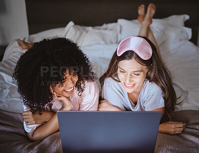 Buy stock photo Laptop, movie and happy with friends in bedroom for sleepover, bonding and streaming. Technology, internet and relax with women lying on bed at night for cinema, subscription and film entertainment
