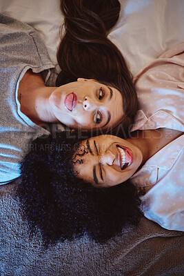 Buy stock photo Comic friends, bed and face of women happy about a sleepover, quality time and fun in pajamas. Gen z people excited and funny in a bedroom with diversity, motivation and happiness in a bedroom